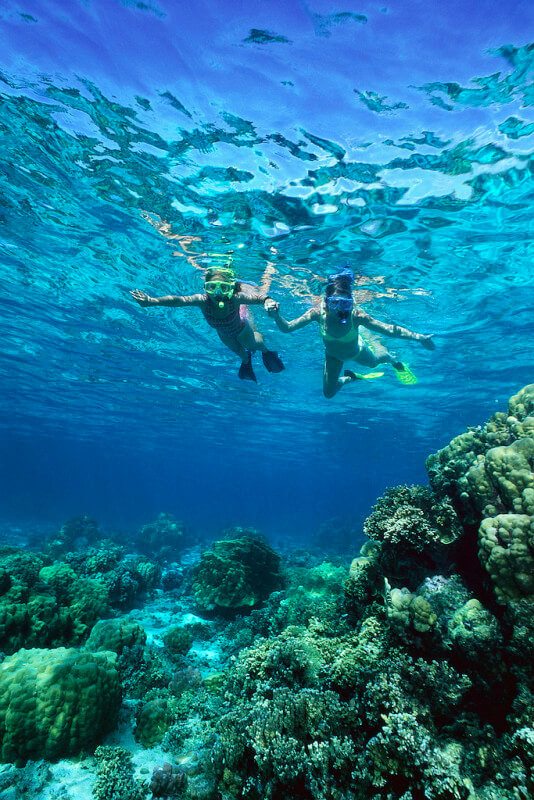 Girls Snorkeling over Reef